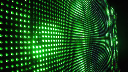 Green LED light pattern glowing against a dark tech-themed backdropの素材