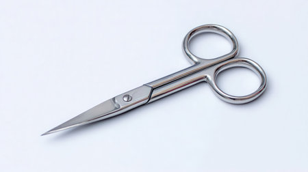 Small grooming scissors with rounded tips resting diagonally on clean white backgroundの素材