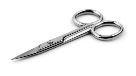 Side angle of stainless mustache scissors showing polished finish on white backgroundの素材