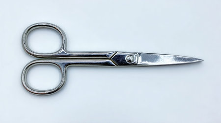 Silver grooming scissors for facial trimming laid horizontally on white backgroundの素材