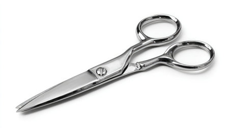 Side angle of stainless mustache scissors showing polished finish on white backgroundの素材