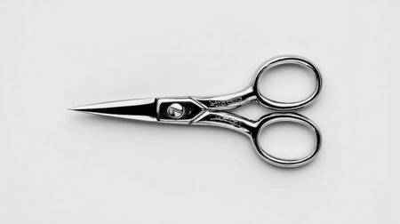 Compact mustache scissors with precision edge shown from top-down on white backgroundの素材