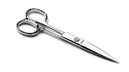 Fine-edged scissors isolated on bright white background, photographed with soft shadowの素材