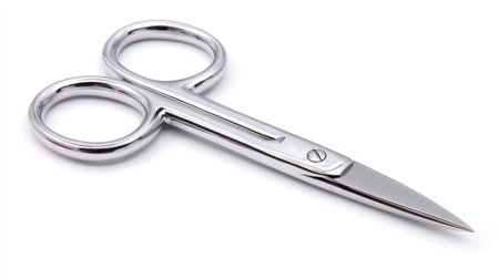 Small trimming scissors with ergonomic design laid flat on white backgroundの素材