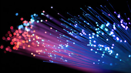 Glowing fiber optic cables symbolize fast digital communication and high-speed dataの素材
