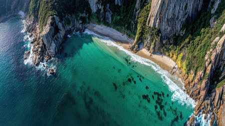 This stunning aerial photograph showcases a tranquil tropical beach bordered by towering cliffs and vibrant turquoise waters, perfect for relaxation.の素材