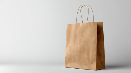 A stylish brown paper shopping bag with sturdy handles and a clean design, perfect for retail and eco-friendly packaging solutions.の素材