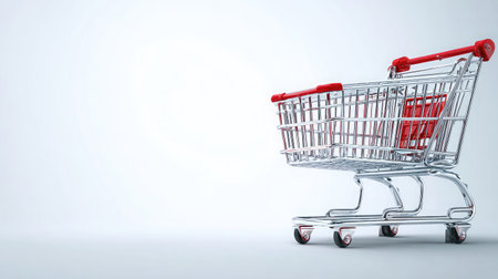 An empty shopping cart sits on a clean, light background, representing themes of retail and consumerism for business and personal finance applications.の素材