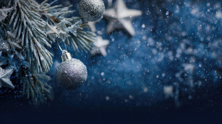 A beautiful close-up of a frosted Christmas tree branch adorned with silver ornaments and stars, set against a vibrant blue background, creating a magical holiday ambiance.の素材
