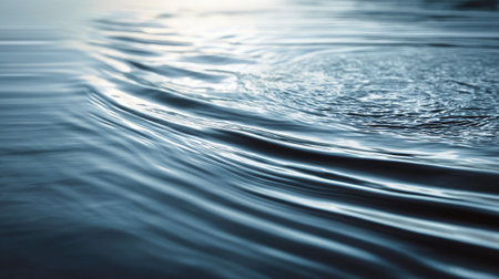 A captivating close-up image showcasing the serene surface of calm blue water with gentle ripples and soft light reflections, perfect for evoking tranquility.の素材