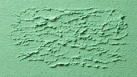 A captivating textured green wall surface, showcasing unique patterns that create depth and visual interest. Ideal for creative projects, backgrounds, and design.の素材