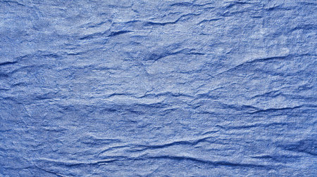 This image features a textured blue fabric background showcasing natural creases and depth. Ideal for creative design projects, textiles, and artistic presentations.の素材