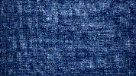 A visually appealing close-up of a textured deep blue fabric surface, showcasing a fine weave pattern ideal for design projects and background use.の素材