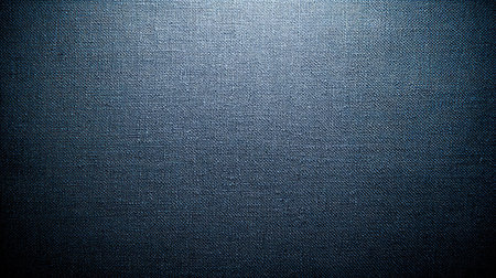 A textured blue fabric background featuring subtle weave patterns, ideal for various design projects, digital applications, and print materials. The smooth surface provides an elegant backdrop for creative works.の素材