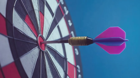 A dart hitting the bullseye on a target board, illustrating precision in achieving business objectivesの素材