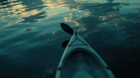 A serene view of a kayak on calm water during sunset, reflecting soft clouds and evening light, perfect for nature and adventure enthusiasts seeking tranquility.の素材