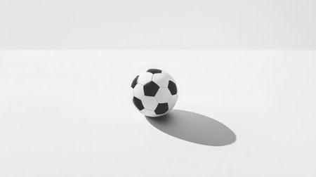 A simple yet striking soccer ball on a smooth minimalist surface. Ideal for use in sports-related designs, advertisements, or promotional materials showcasing athleticism and teamwork.の素材