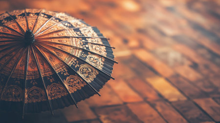 A beautifully crafted traditional umbrella featuring intricate patterns, set against a rustic wooden background, ideal for themes of culture, art, and elegance in creative projects.の素材