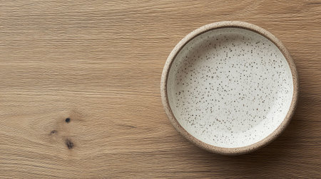 A stunning minimalist ceramic bowl rests gracefully on a wooden table, showcasing an elegant speckled design that complements modern kitchen aesthetics and enhances dining experiences.の素材