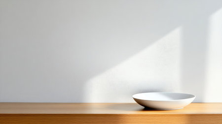 A minimalist arrangement featuring a white plate on a wooden shelf illuminated by soft light. This design captures tranquility and elegant simplicity, ideal for contemporary interiors.の素材