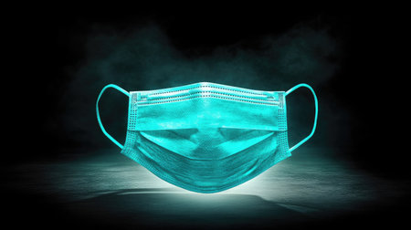 This striking image features a surgical mask illuminated against a dark background, showcasing its detailed texture and vibrant color, perfect for healthcare-related themes.の素材