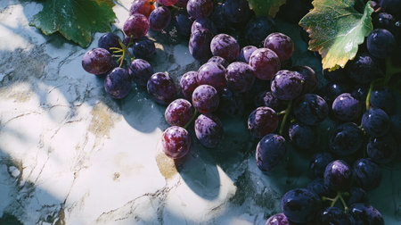 A beautiful arrangement of fresh purple grapes on a marble surface, showcasing their vibrant color and natural texture. Perfect for food and health themes.の素材