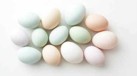 This image captures a beautiful collection of pastel eggs arranged on a white background, ideal for spring themes, Easter celebrations, or creative decoration ideas.の素材