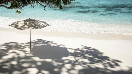 A serene beach scene featuring a simple umbrella casting shadows on the soft sand, with gentle waves lapping at the shore, perfect for relaxation.の素材