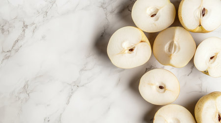 Freshly sliced apples arranged on a sleek marble surface, ideal for food styling and healthy eating concepts. Perfect for recipes and culinary design.の素材