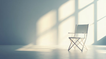 A minimalistic chair bathed in sunlight casts soft shadows against a bright wall. This serene setting evokes calmness, making it perfect for various design concepts and lifestyle projects.の素材