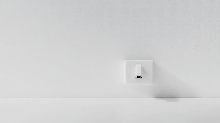 This image features a minimalist wall outlet and plug socket against a plain white background, embodying contemporary design principles and simplicity in modern interiors.の素材