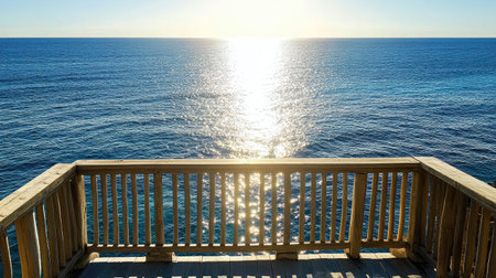 Balcony scene at sunrise with warm light pouring onto the deck and sea sparklingの素材