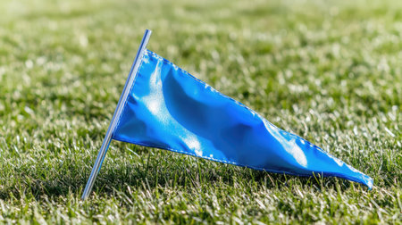 A broken corner flag lying on the grass, symbolizing a hard-fought football match.の素材