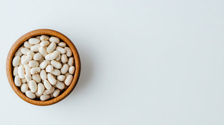 A selection of white beans in a small dish on a minimalistic white background.の素材