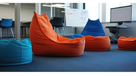 A tech startup workspace featuring bean bags, whiteboards, and vibrant modern furniture.の素材