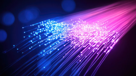 Fiber-optic strands forming a luminous web of light across a dark, futuristic spaceの素材