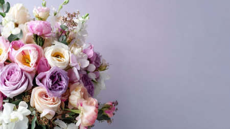A stunning floral display featuring a mix of pastel roses, peonies, and orchids on a soft purple background, ideal for adding beauty to events and occasions.の素材