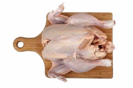 The whole hen close up on kitchen board isolated on white backgroundの写真素材