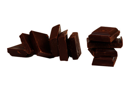 Slices of dark chocolate isolated on white background