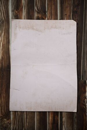 Old paper on wooden backgroundの写真素材