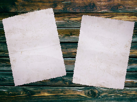 Old photo paper on wooden backgroundの写真素材