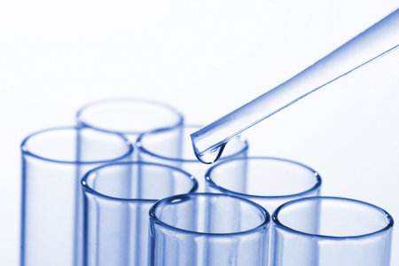 Row of test tubes in dramatic lighting with room for body copy