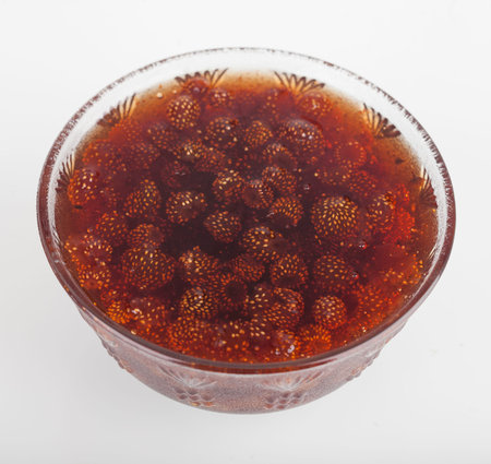 Cup of strawberry jam on white backgroundの写真素材