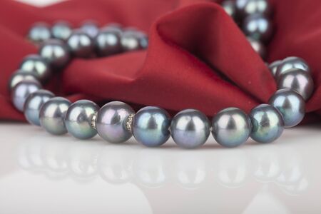 Pearls necklace on satin backgroundの写真素材