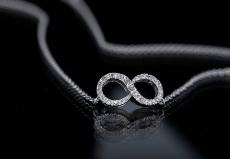 infinity necklace on black background