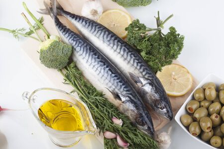 Fresh mackerel on wood with vegetablesの写真素材