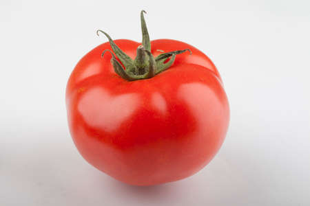 tomato on a kitchen wooden boardの写真素材