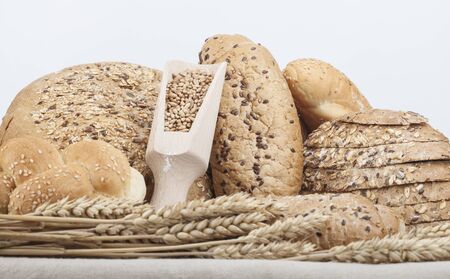 fresh bread and wheat on the white woodenの写真素材