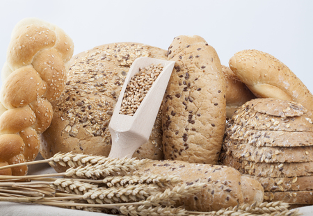 fresh bread and wheat on the white woodenの写真素材