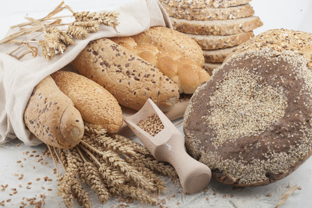 Fresh bread and wheat on the white woodenの写真素材